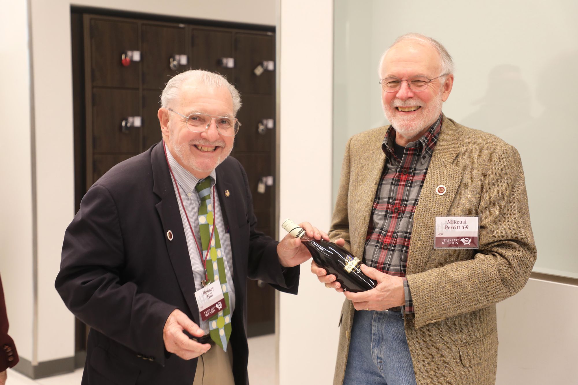 Woodcarvers Rodney Hill and Mikeual Perritt share a laugh at the Music Activities Center.