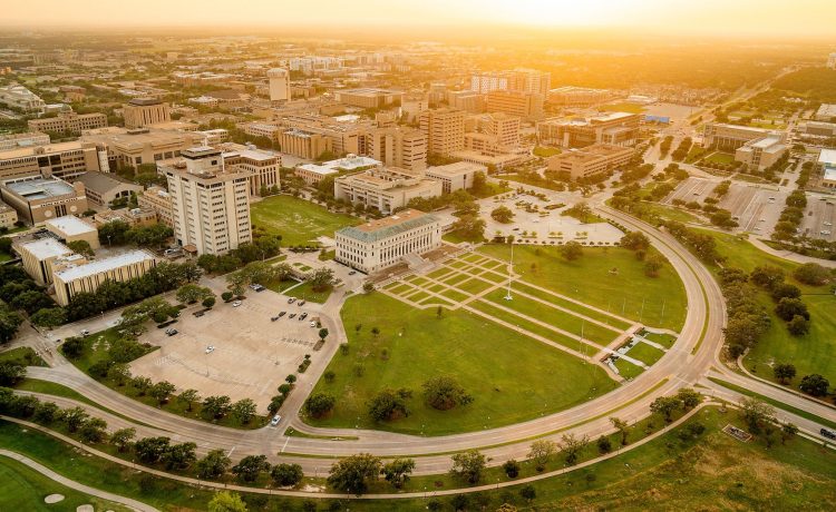The sun sets over the Texas A&M University skyline