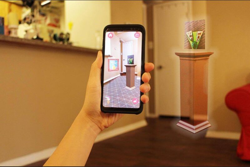 A smartphone app uses augmented reality to preview furniture to furnish a room