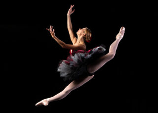 A ballerina leaps in midair