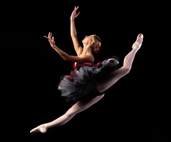 A ballerina leaps in midair