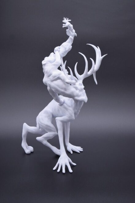 3D printed sculpture of a jackalope coming out of the mouth of a dog, which is coming out of a hippo, which is coming out of a creature with antlers and humanoid hands.
