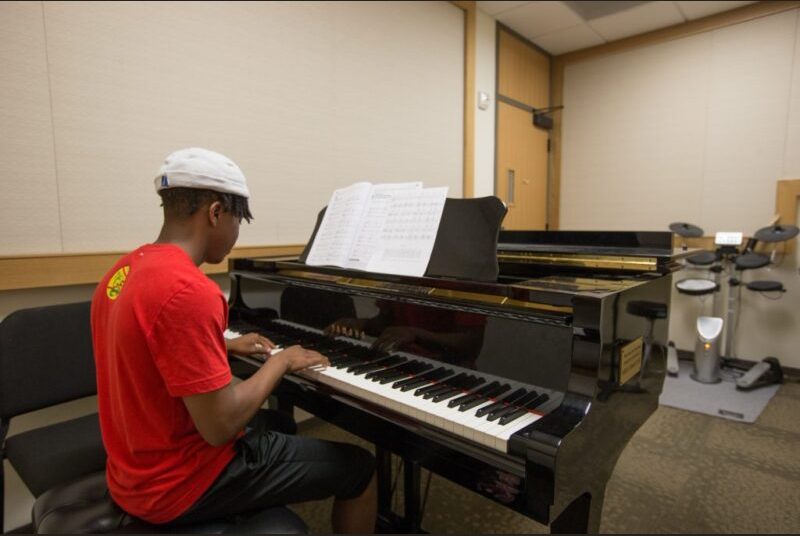 Student playing a piano