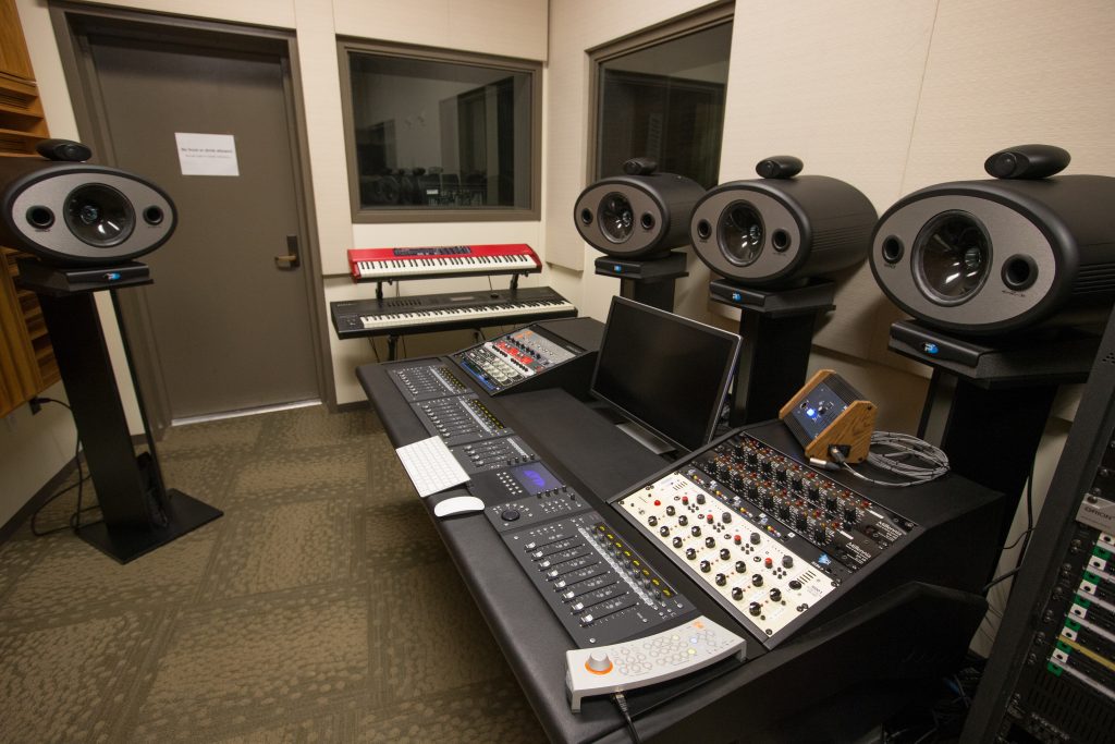 Complex audio mix board inside a recording studio