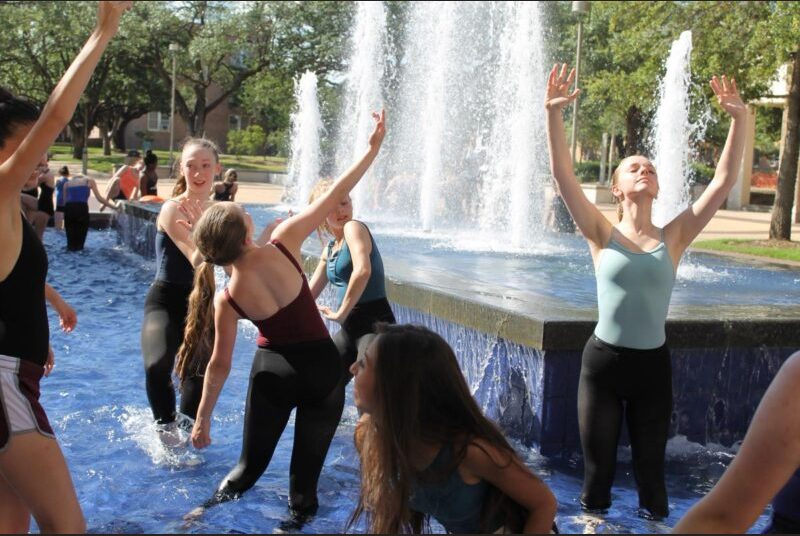 Students dance in a fountain outside of the MSC
