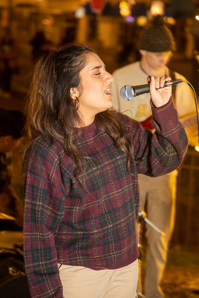 A singer performs with a band at the Lights On! event.
