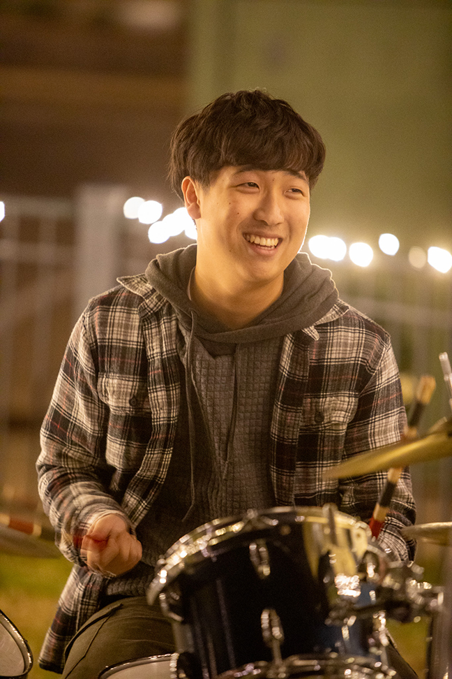 A drummer performs with a band at the Lights On! event.