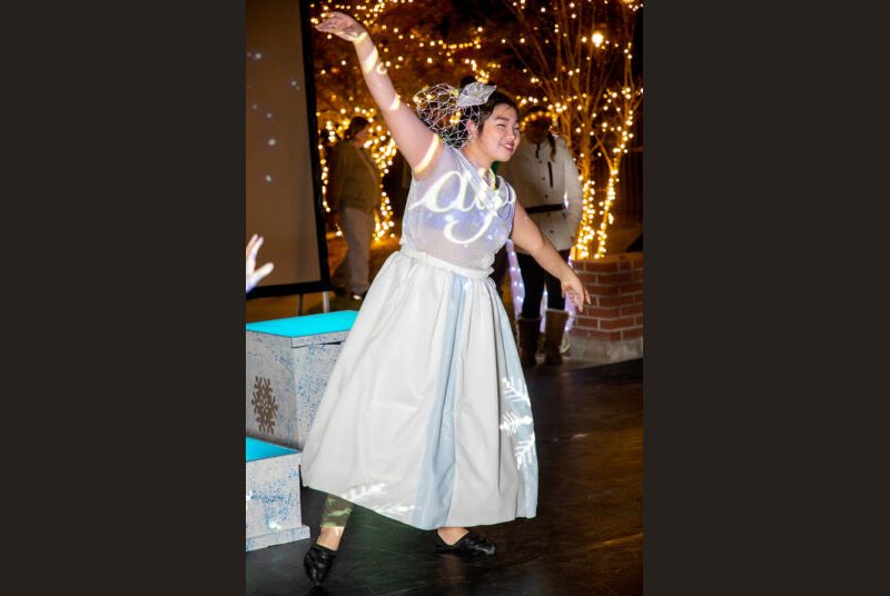 A dancer performs at an outdoor event.