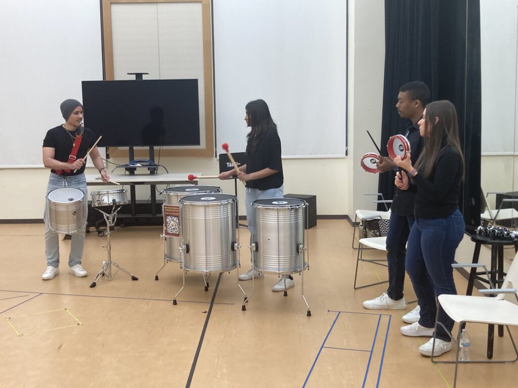 Members of a Brazilian percussion ensemble perform.