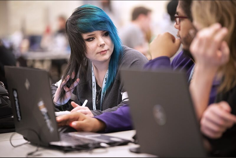 Three college students discuss creating a game at the Chillennium game jam.