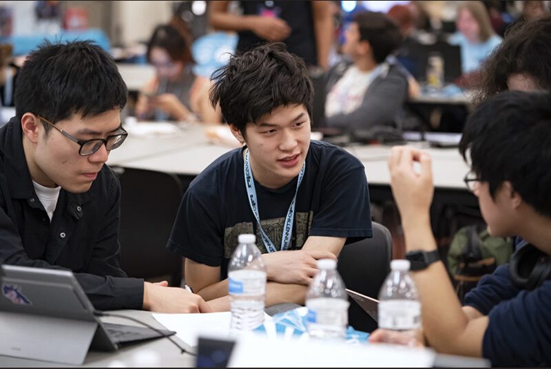 Three college students discuss creating a game at the Chillennium game jam.