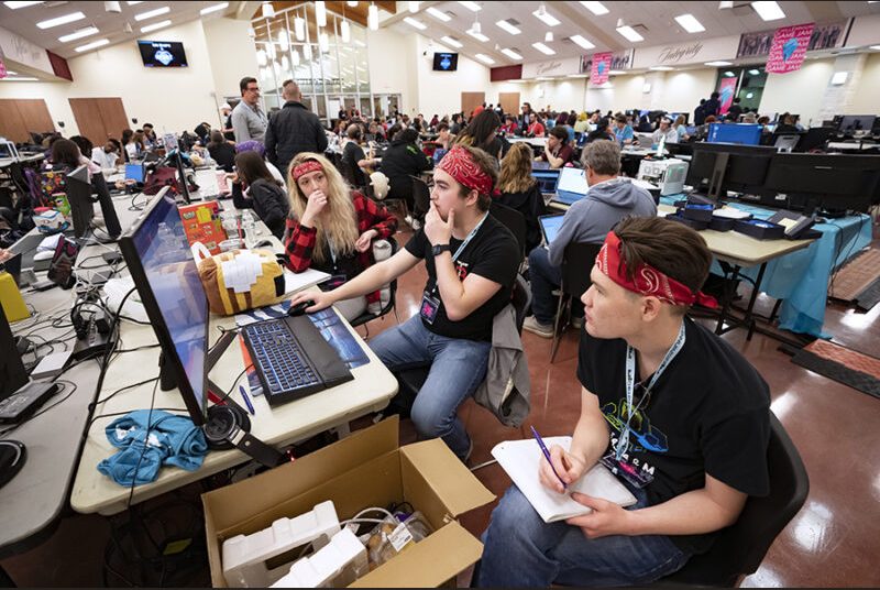 Three college students work on developing a game at the Chillennium game jam.