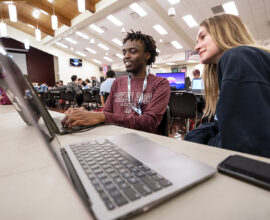 Two college students discuss creating a game at the Chillennium game jam.