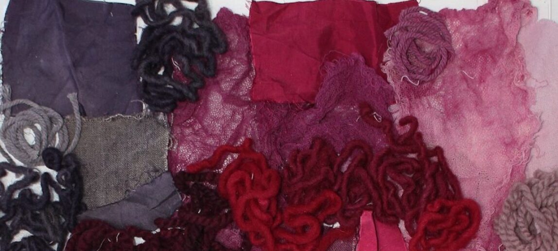 Several examples of textiles that have been dyed shades of red through working with cochineal insects