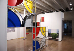 Two square structures in red, yellow, blue and white in an art gallery.
