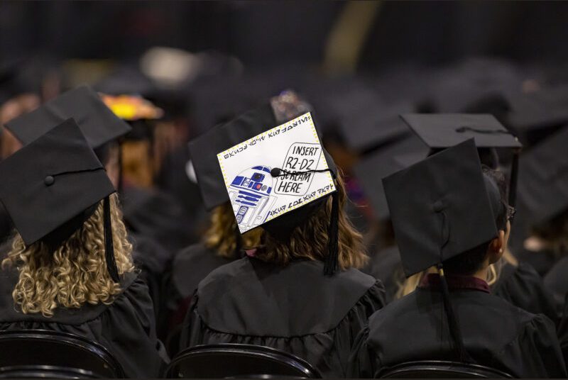 A graduating college student with a decorated graduation cap.