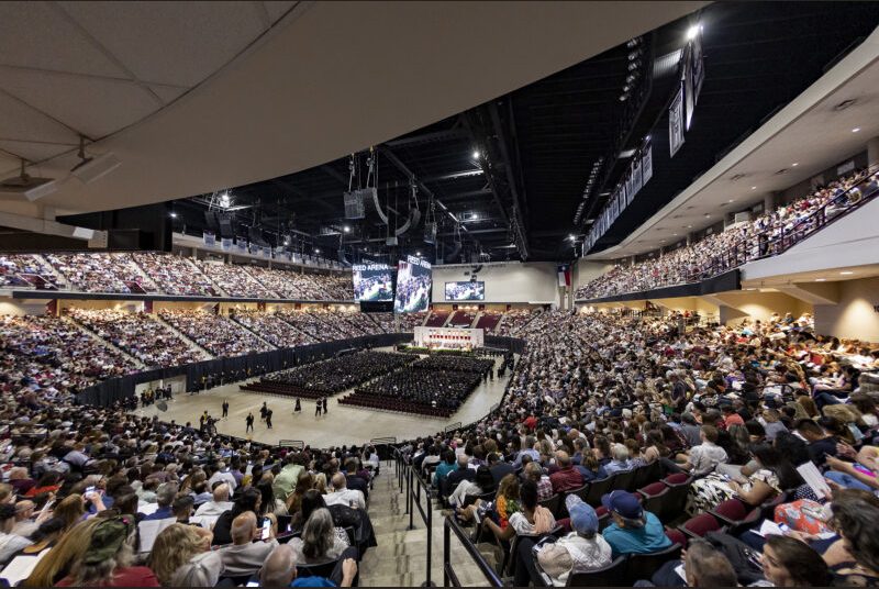 A wide view of the crowd at a college graduation ceremony.