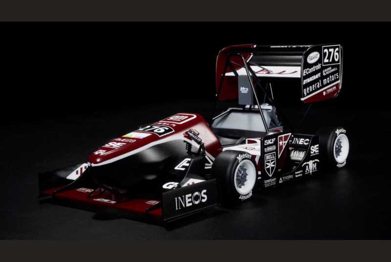 An illustration of a Formula 1 car in maroon and black with Texas A&M logos.