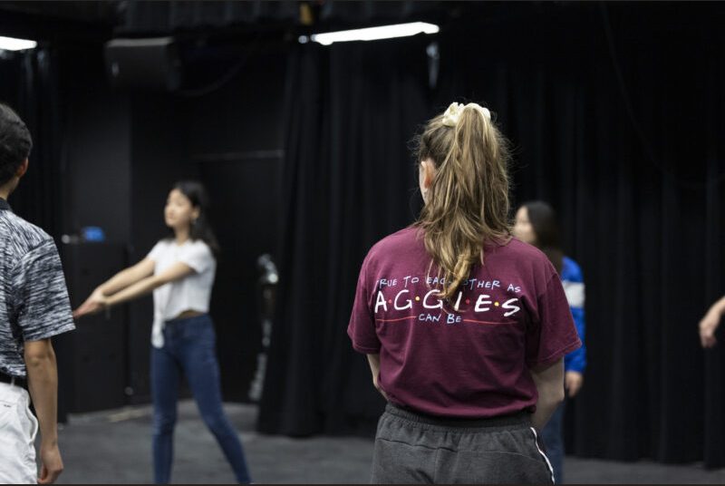 College students participate in an acting improv workshop at an art party.