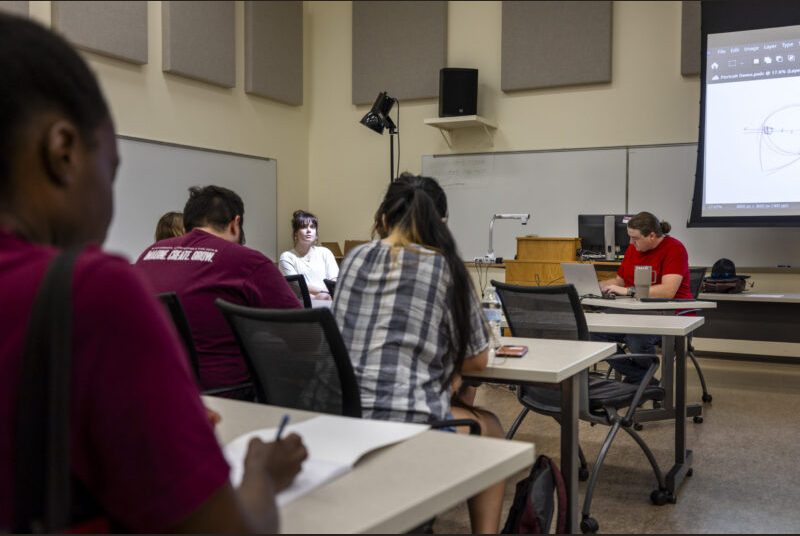 College students participate in a drawing workshop at an art party.