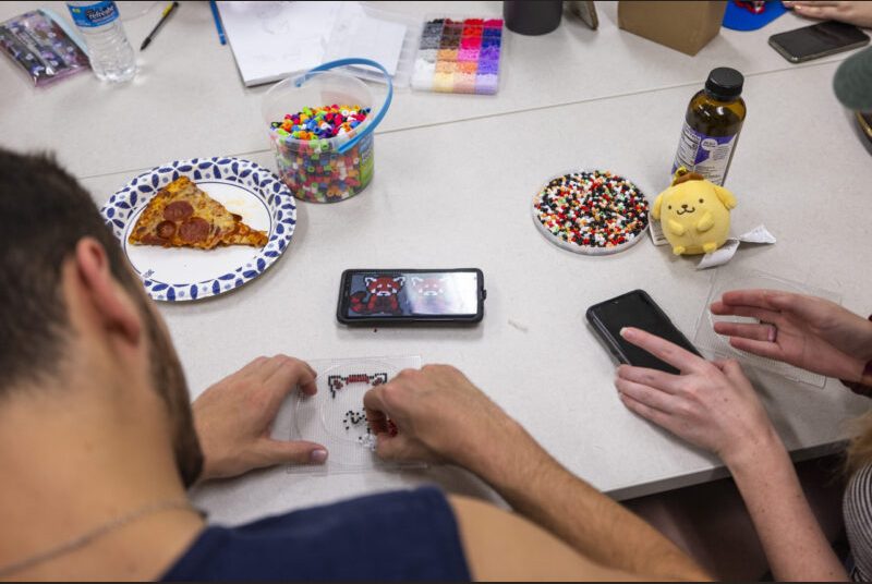 Students work on a craft project at an art party.