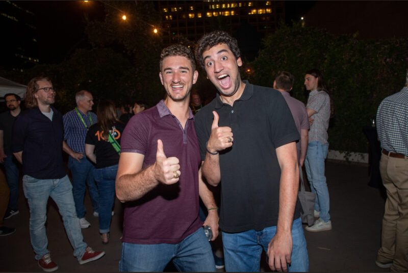 Two people smile for a photo at a party