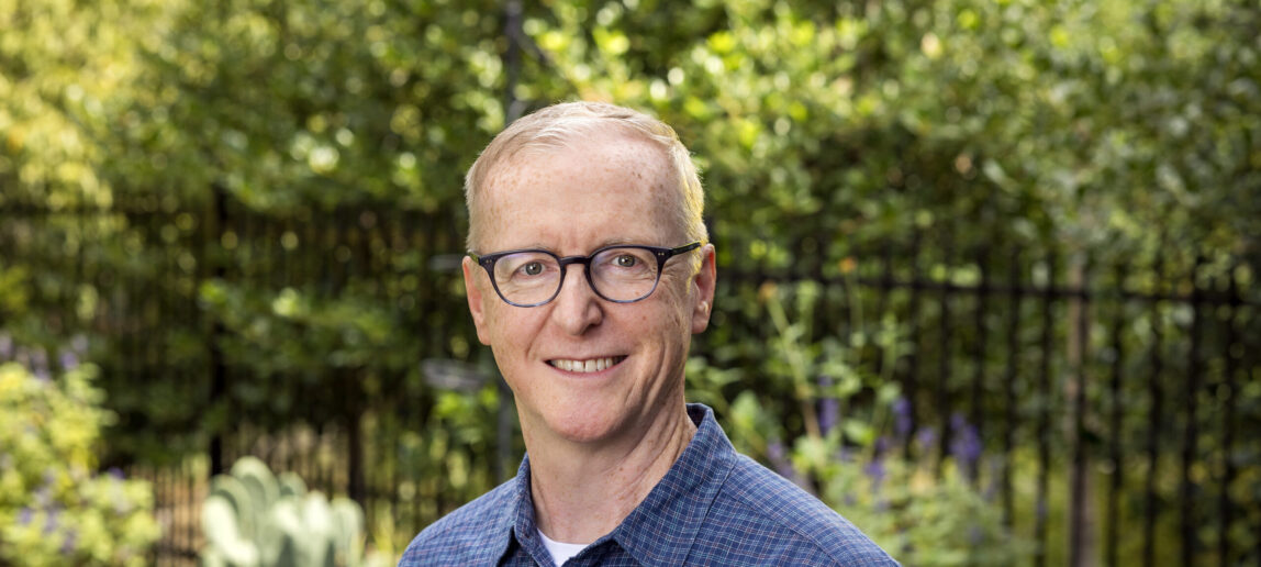 A portrait of a man in an outdoor setting.