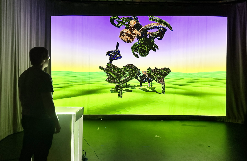A screen with bright green and purple colors shows a project titled "Connected Immersion Birth-Death-Rebirth."