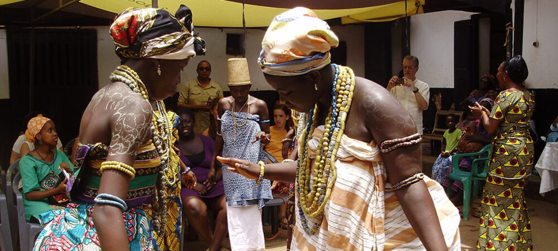 An image of two young women dressed with clusters of beads as part of the Dipo puberty rite ceremony among the Krobo-Odumase people in the Eastern region of Ghana.