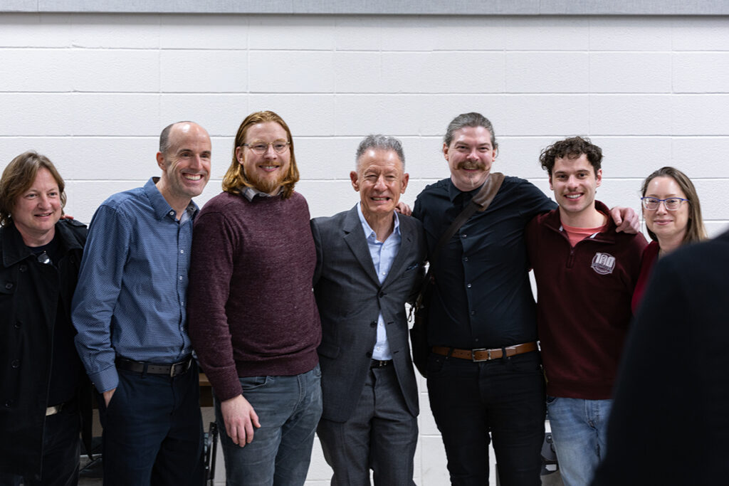 Singer-songwriter Lyle Lovett poses for a photo six faculty and staff members.