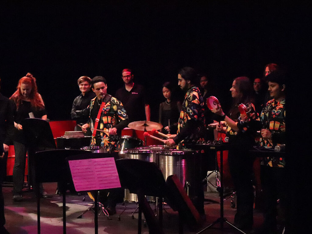 A percussion ensemble performs onstage.