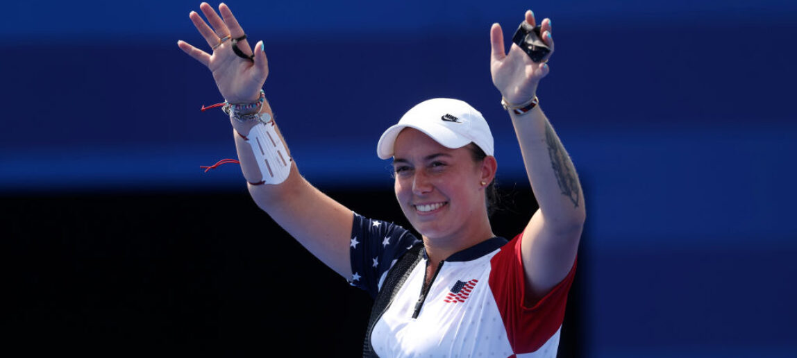 An Olympic archer raises her hands in victory and smiles at the Olympic Games in Paris.