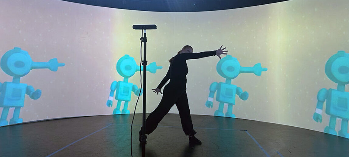 A student moves in front of a 360-degree screen, with the images displayed on the screen tied to her movements.