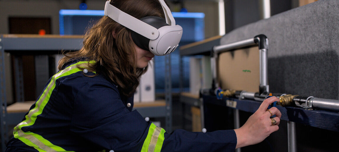 A student wears an augmented reality headset device while exploring a simulated environment.